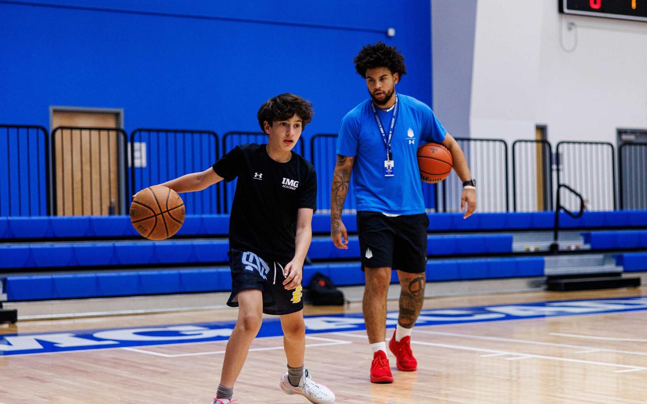 camper and coach at img basketball camp